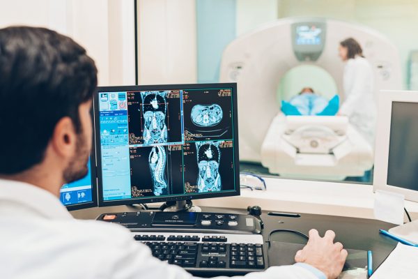 Doctor looking at a monitor with patient's MRI scan results